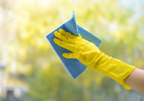 Carpet cleaning technician using protective equipment during a safe service