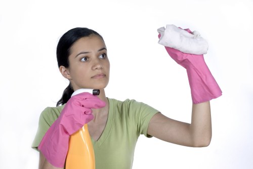 Carpet cleaning staff member following safety procedures near a treated floor area